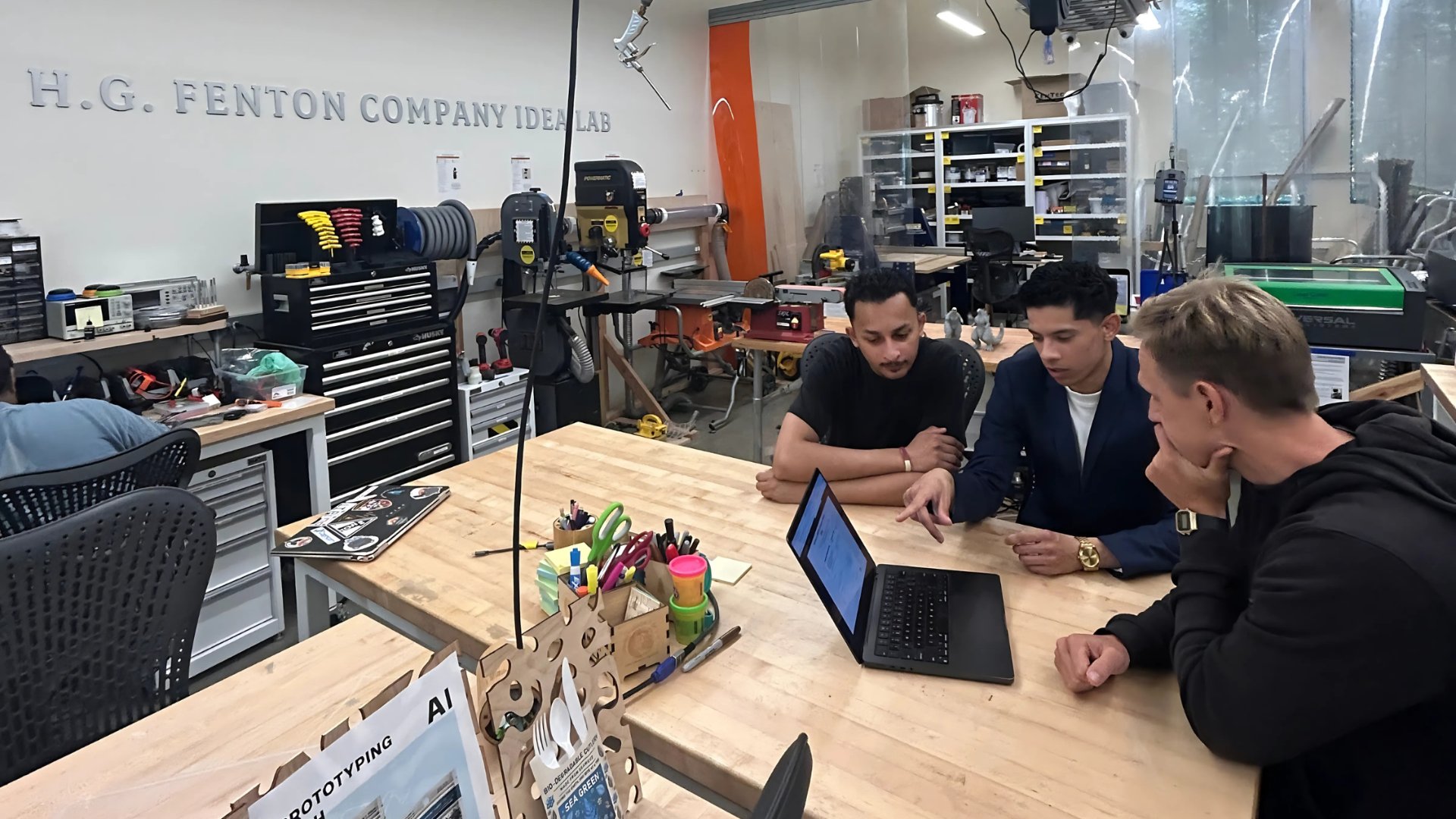 Group of people looking over laptop at the lab